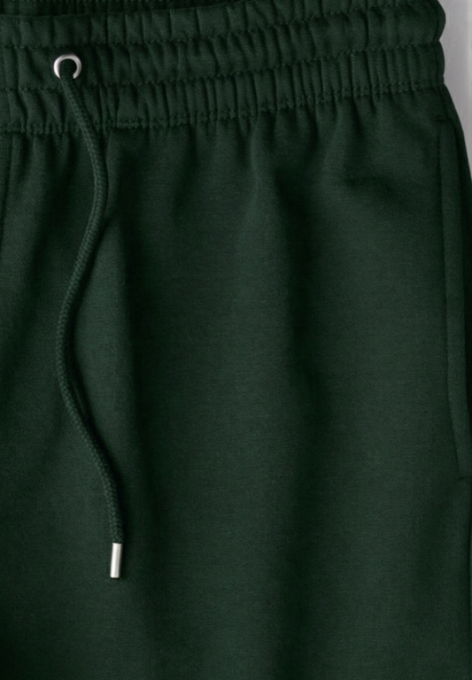 Bottle green joggers with a drawstring on a gray background