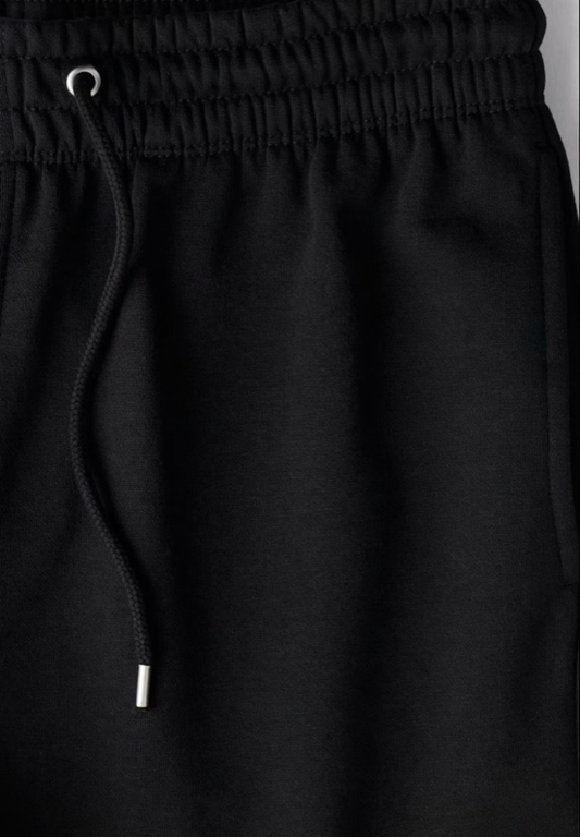 Black Jogger drawstring pants on a plain background