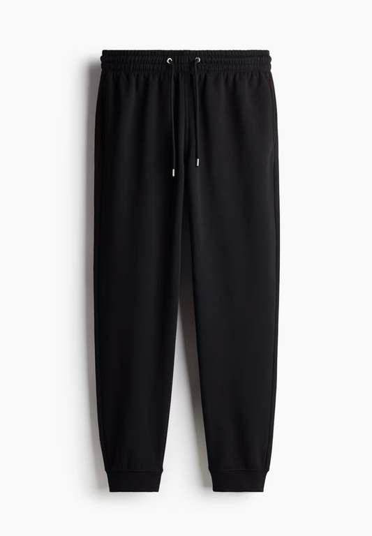 Black jogger pants on a white background