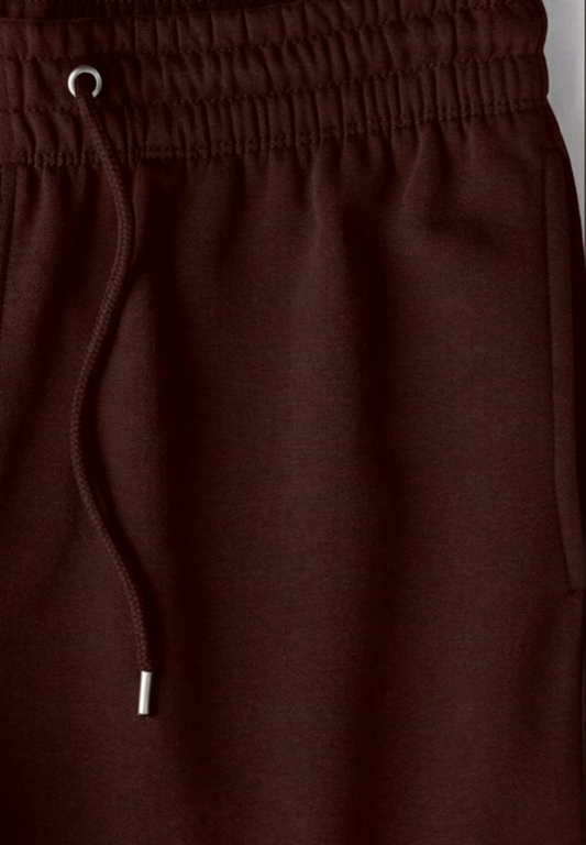 Close-up of Maroon joggers with a drawstring on a gray background