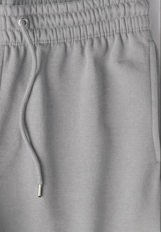 Close-up of grey joggers with drawstring