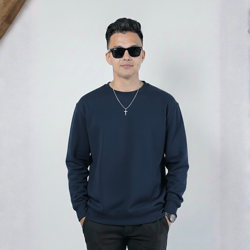 Man wearing a navy blue sweatshirt and sunglasses against a white background